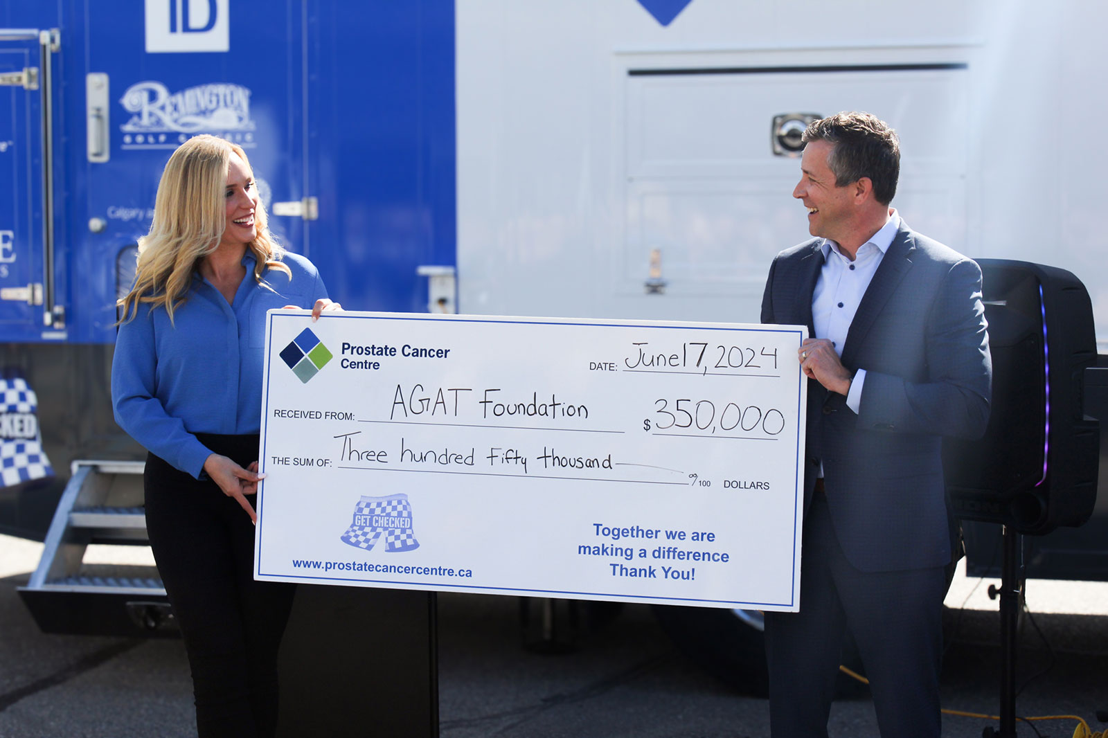 Marissa Reckmann and Jeff Davison holding $350,000 cheque together.