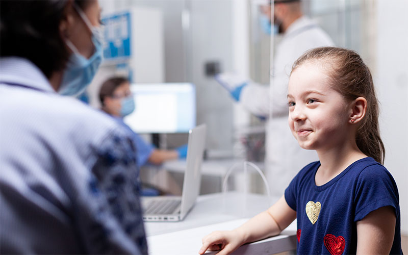 Little Girl at Hospital talking with doctor