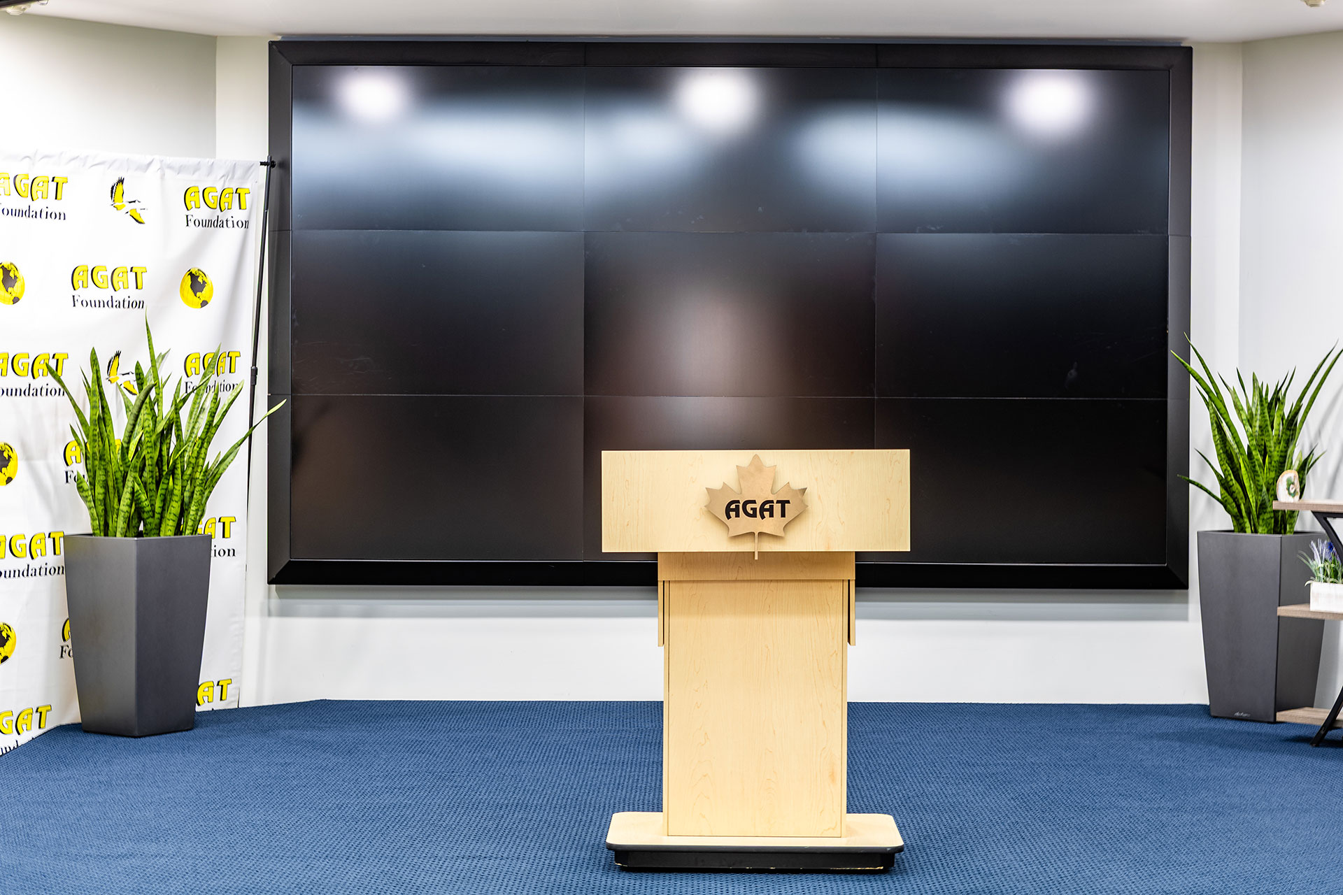 Front-facing view of the AGAT podium and video wall inside the Michael DeSanti Centre for Excellence.