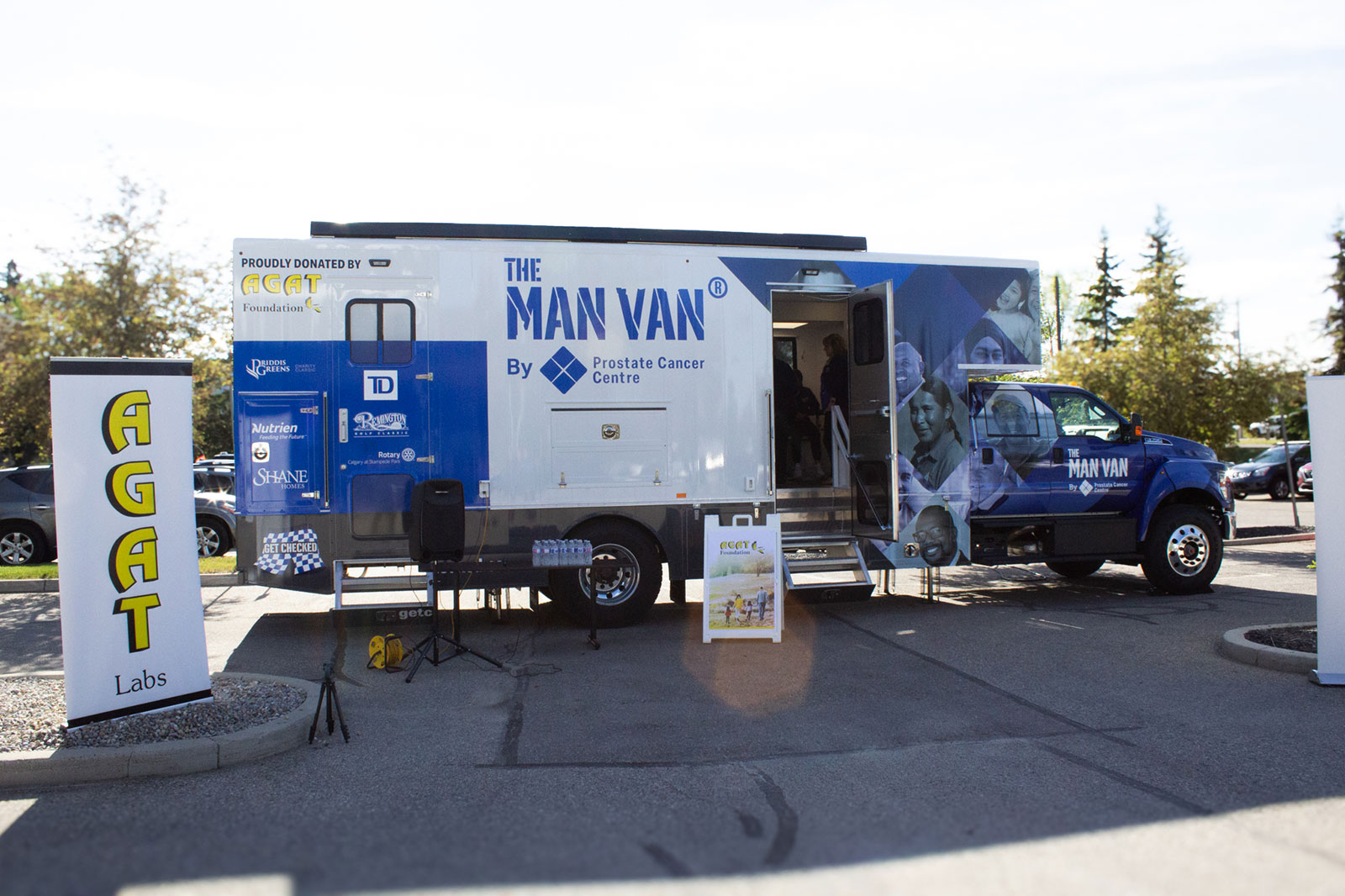 MAN VAN® mobile clinic displayed between AGAT Labs banners.