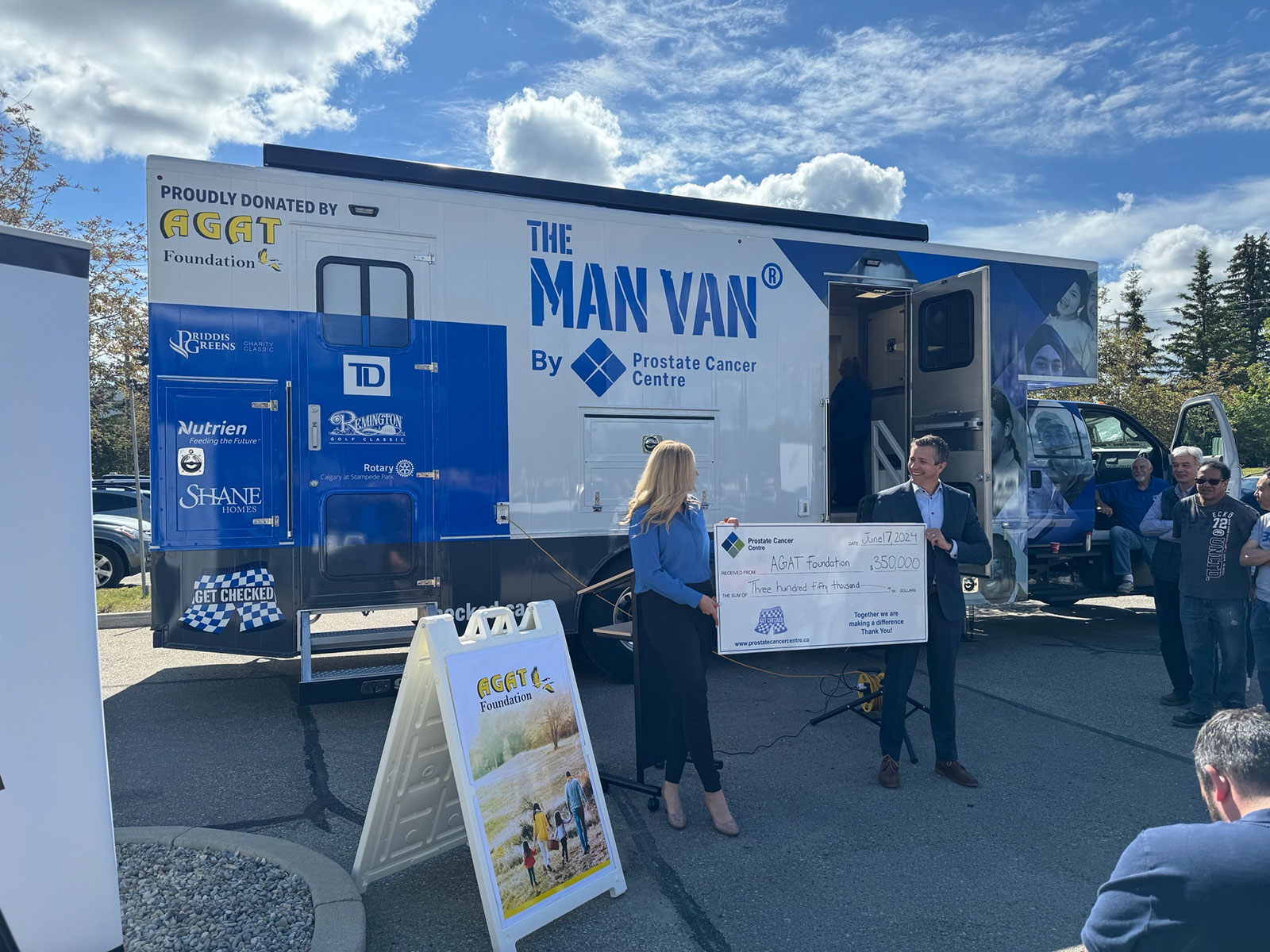 Marissa Reckmann and Jeff Davison holding $350,000 cheque.