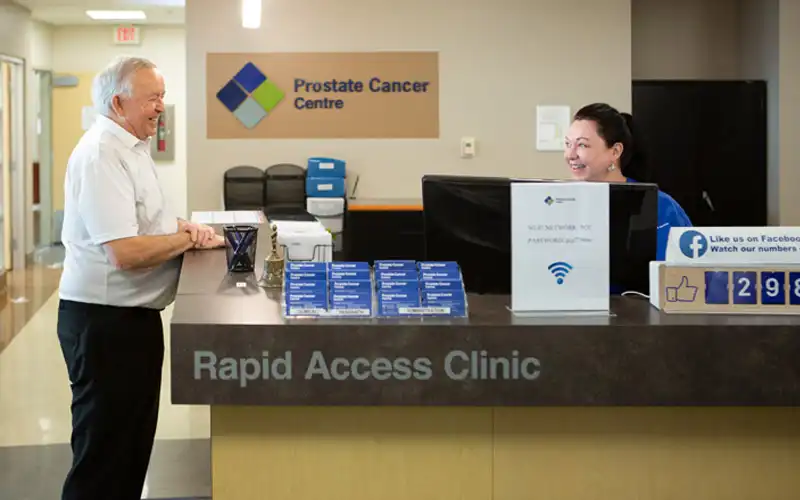 Patient interacting with receptionist at the Rapid Access Clinic, Prostate Cancer Centre.