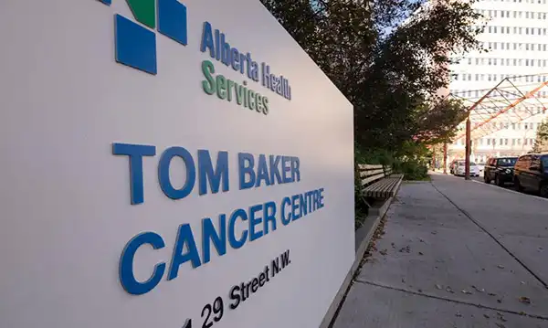 Tom Baker Cancer Centre sign on 29 Street NW Calgary, showing Alberta Health Services branding.
